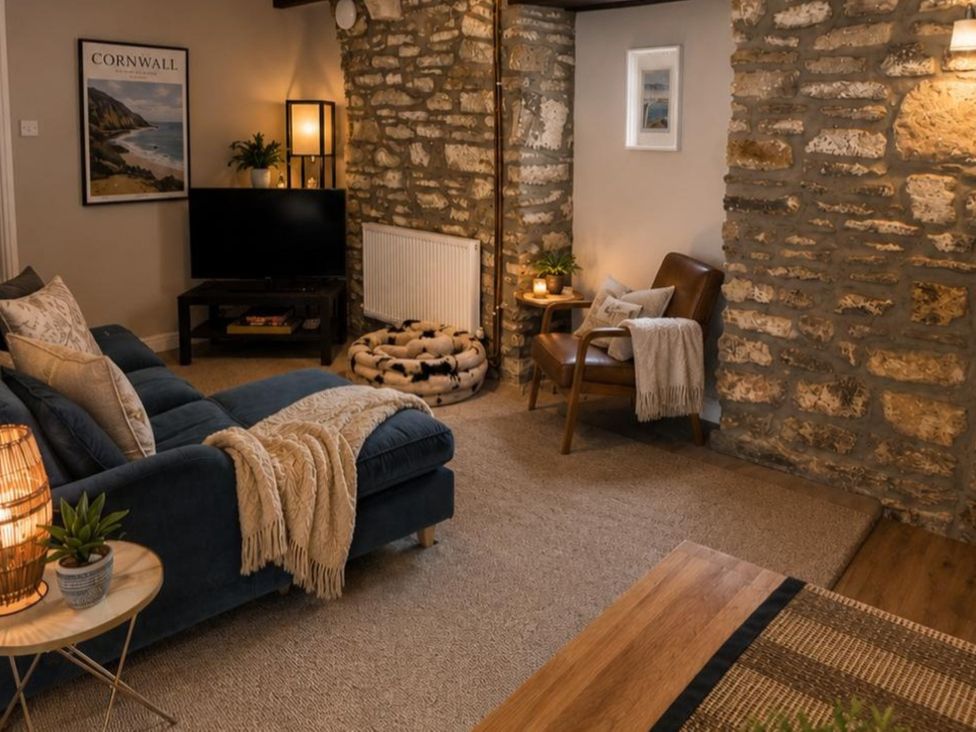 A living room with a television and sofa at Coach House in St Clears