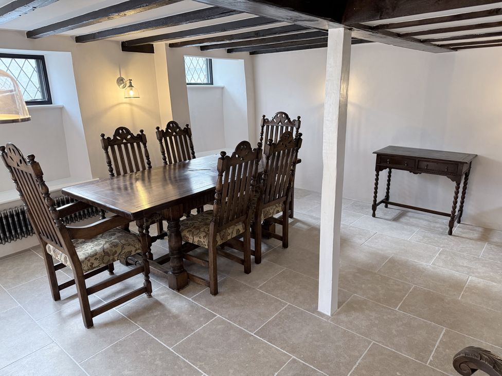 A dining room with a wooden table and chairs at Bridge Cottage in Chideock
