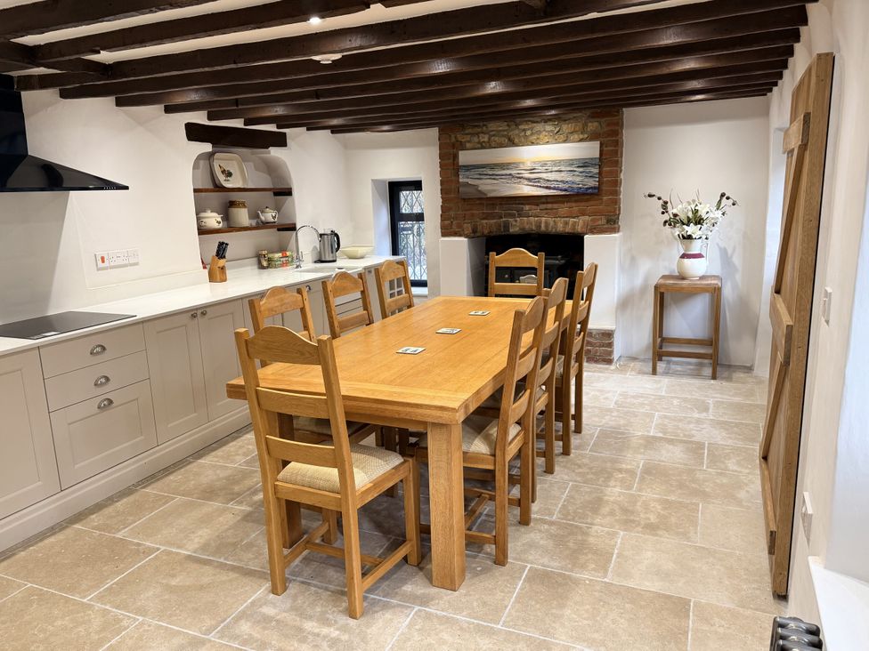 A kitchen with a dining table and chairs at Bridge Cottage in Chideock