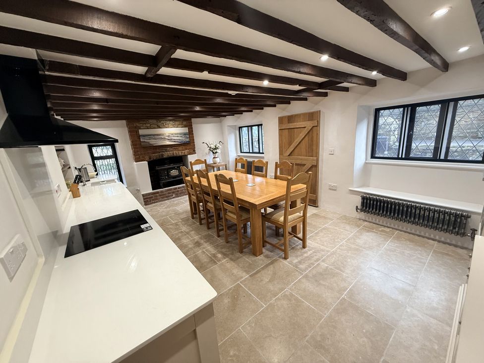 A kitchen with a dining table and chairs at Bridge Cottage in Chideock