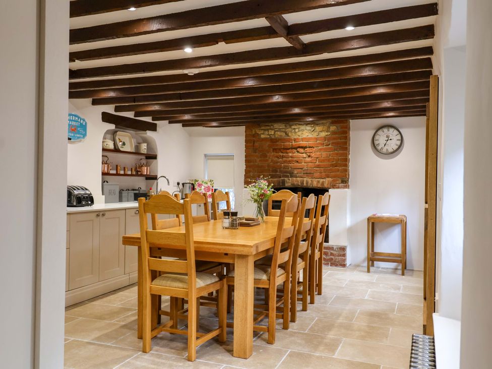 A kitchen with a dining table and chairs at Bridge Cottage, Chideock