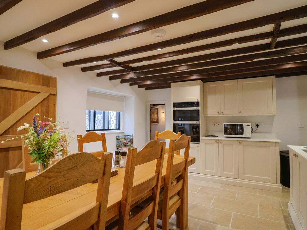 A kitchen with a dining table and chairs at Bridge Cottage in Chideock
