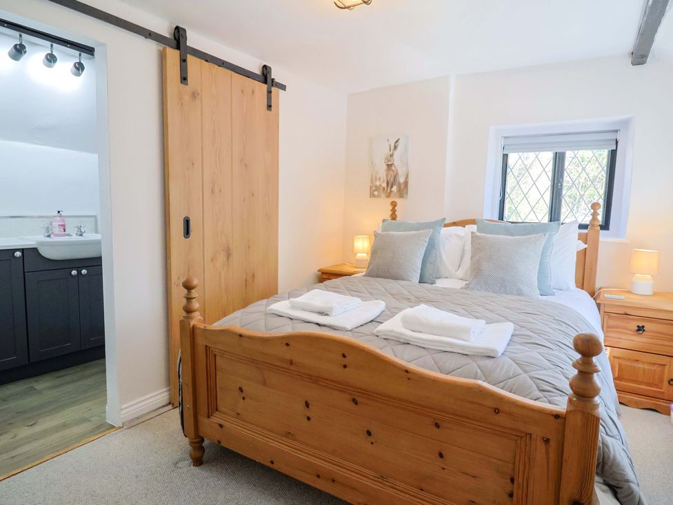 A bedroom with a bed and bedside tables at Bridge Cottage in Chideock