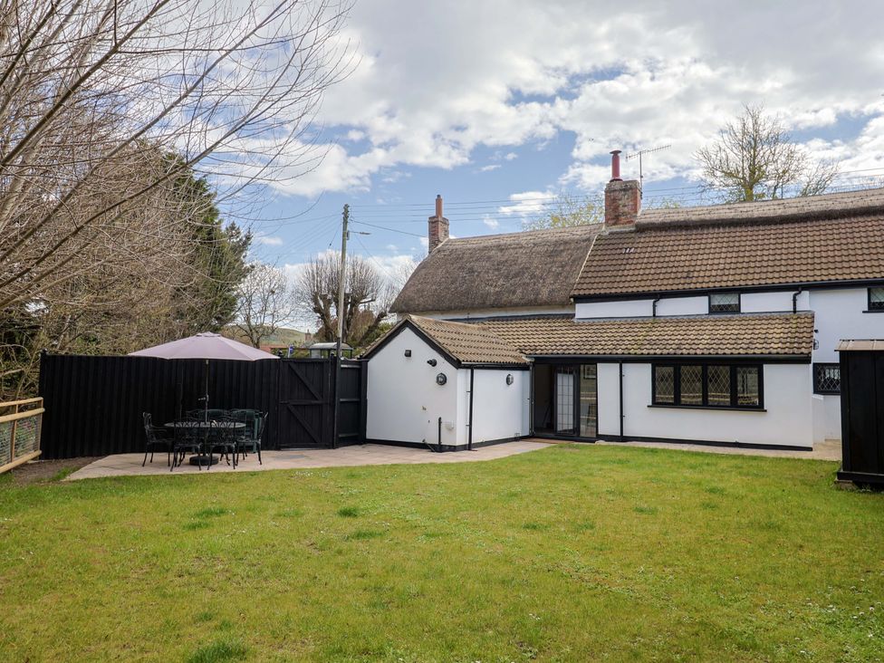 An outdoor area with a table and chairs at Bridge Cottage in Chideock