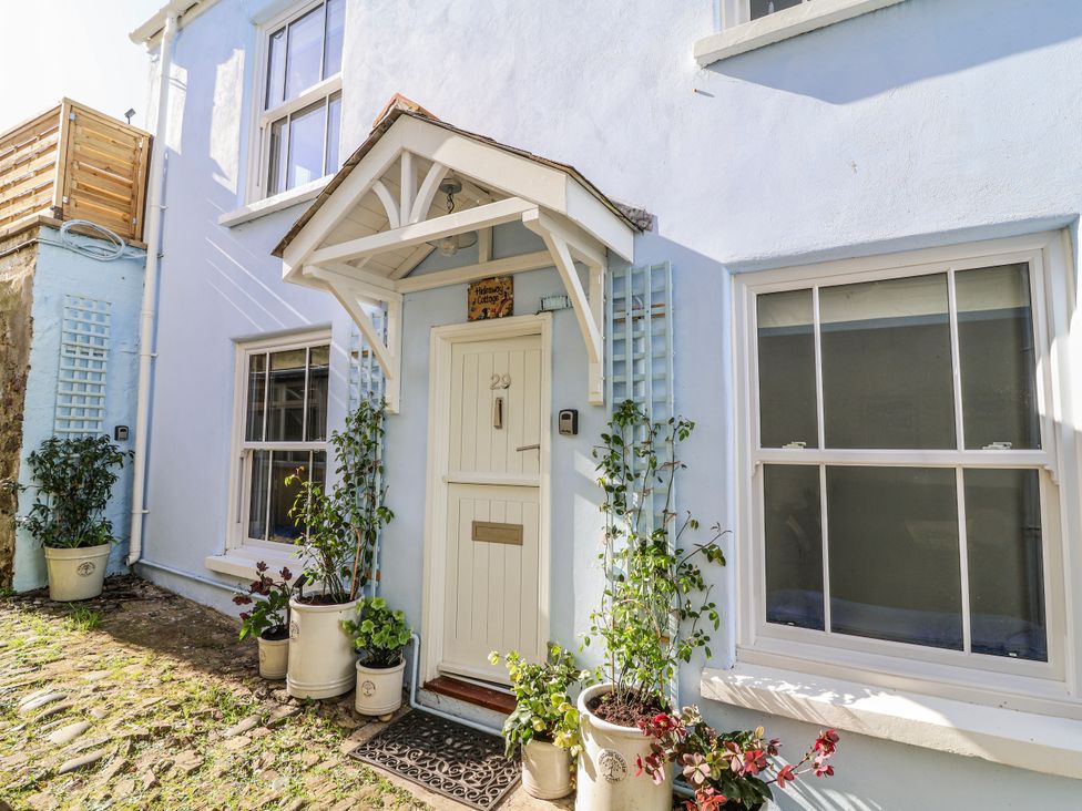 A front entrance with door and plants at Hideaway Cottage