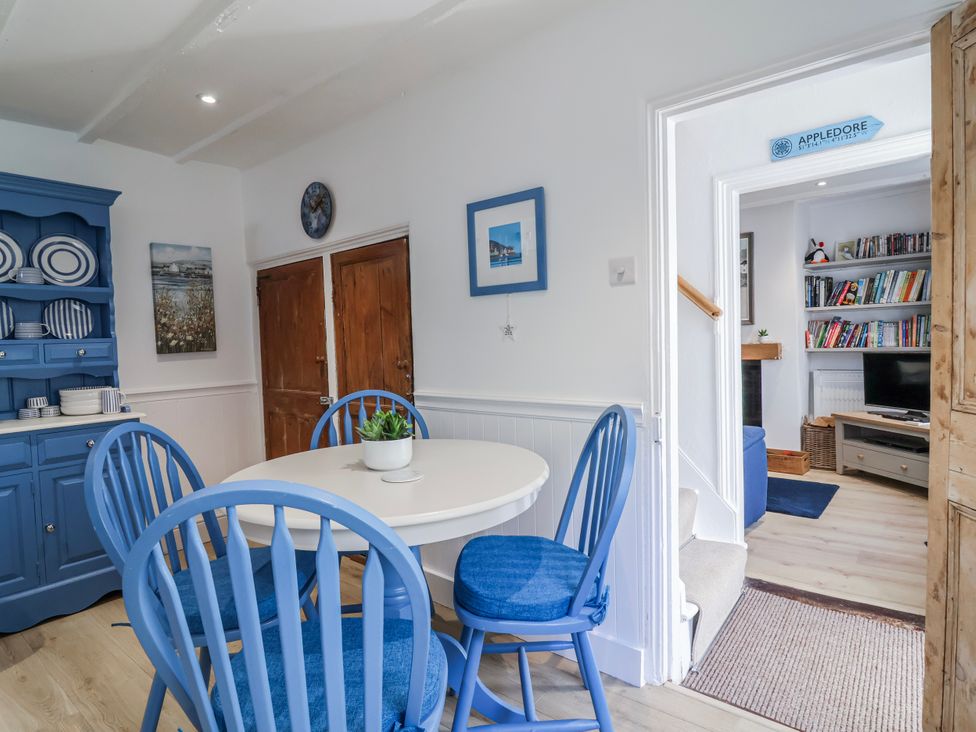 A dining room with a table and chairs at Hideaway Cottage