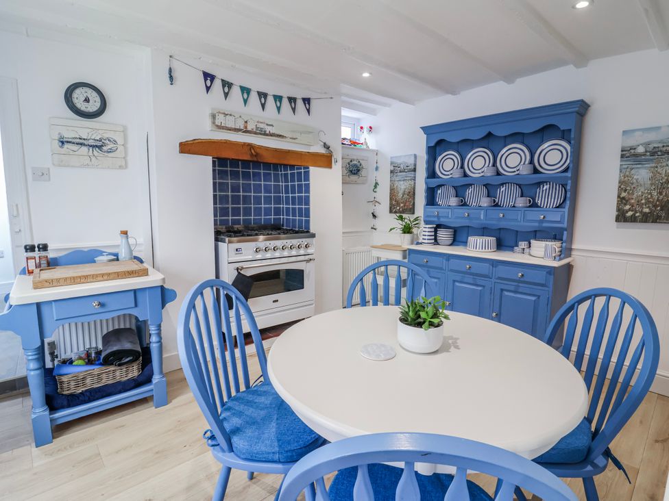 A kitchen with a table and chairs at Hideaway Cottage 