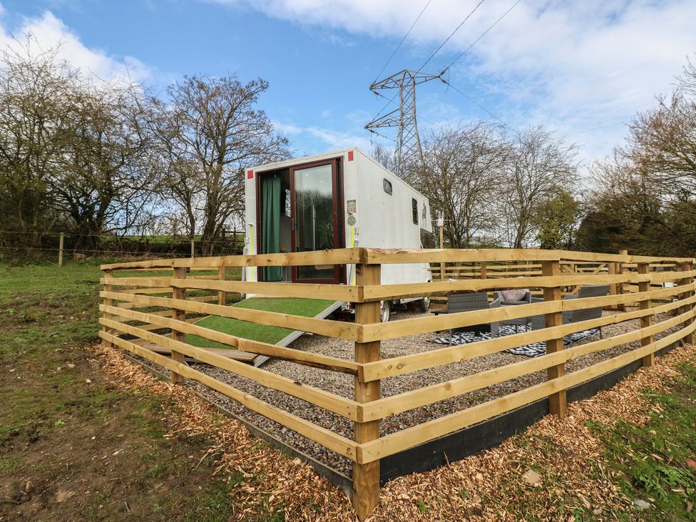 An outdoor space with a trailer and wooden fence at The Horse Box in Blaydon-on-Tyne