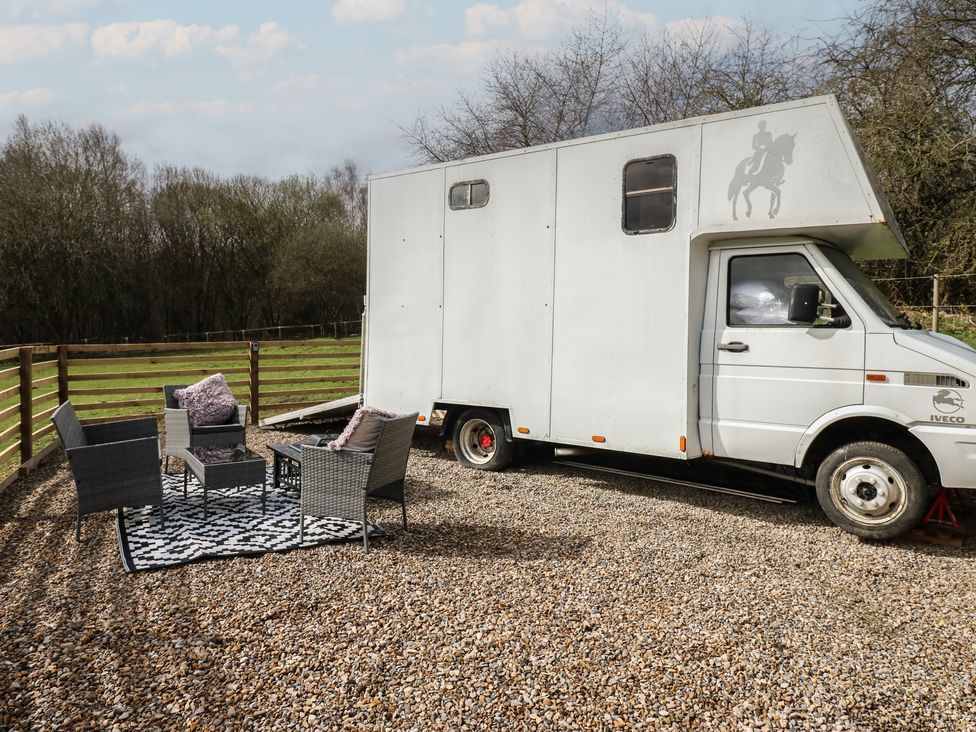 An outdoor area with a horsebox and seating at The Horse Box in Blaydon-on-Tyne