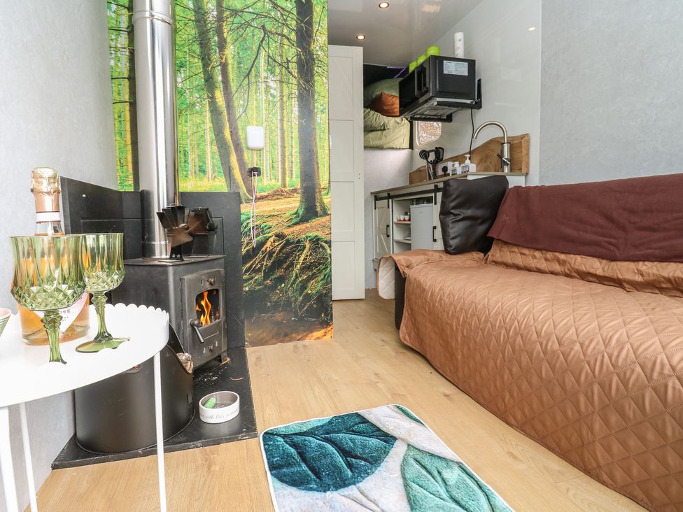 A living room with a fireplace and couch at The Horse Box in Blaydon-on-Tyne