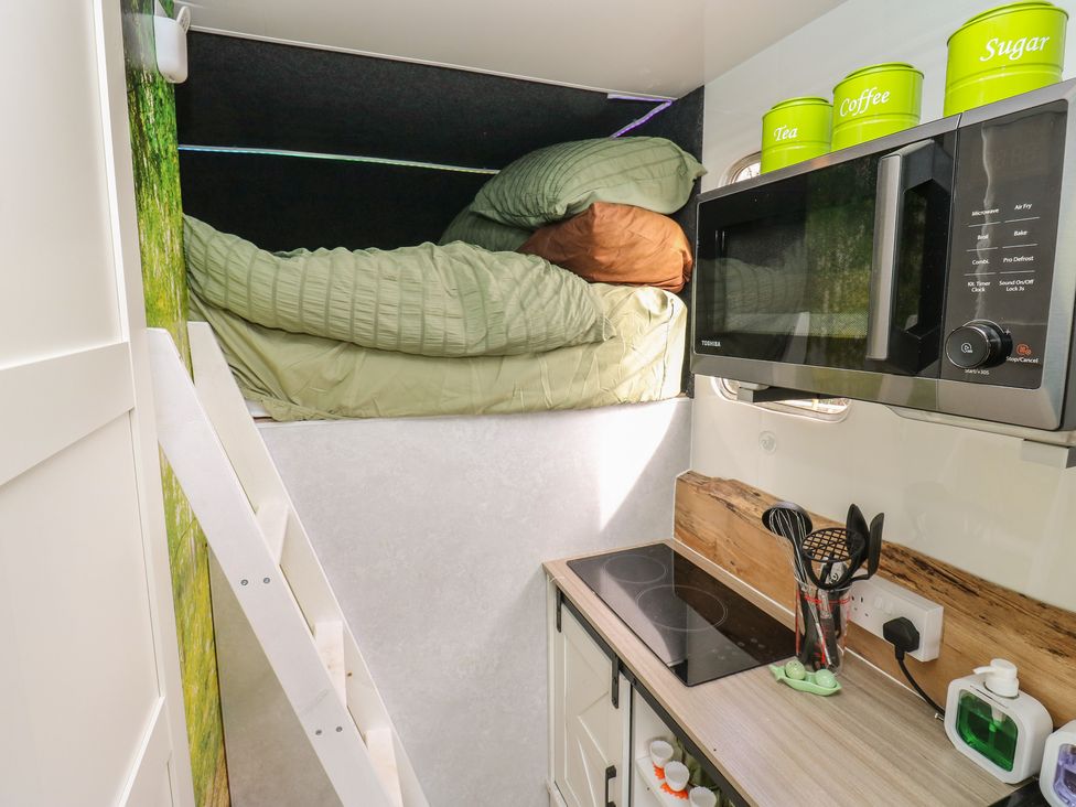 A kitchenette with bed and microwave at The Horse Box in Blaydon-on-Tyne
