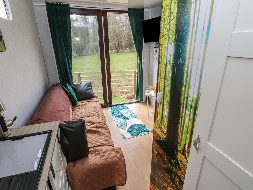 A living room with a sofa and a view of the outdoors at The Horse Box in Blaydon-on-Tyne