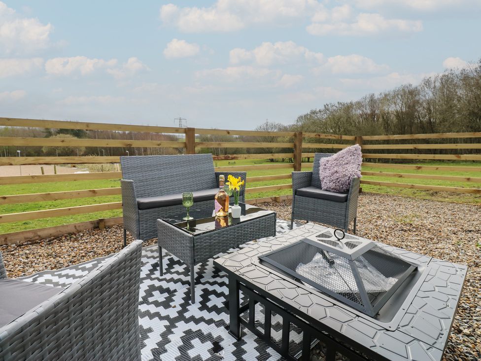 An outdoor seating area with chairs and a table at The Horse Box in Blaydon-on-Tyne