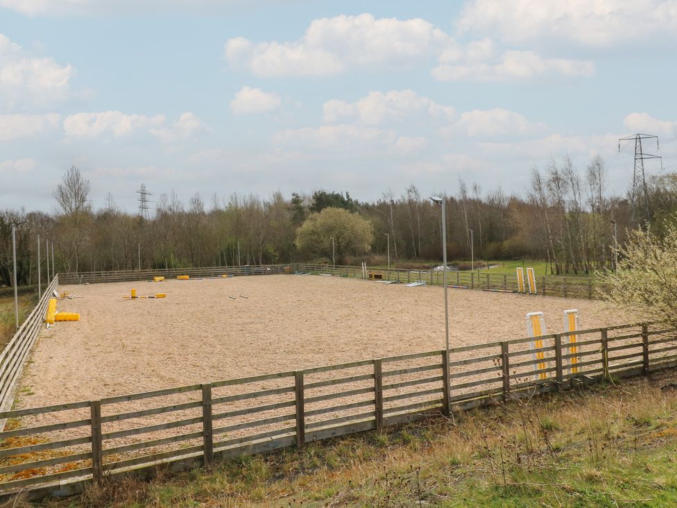 An outdoor horse arena with sand surface and a fence at The Horse Box in Blaydon-on-Tyne