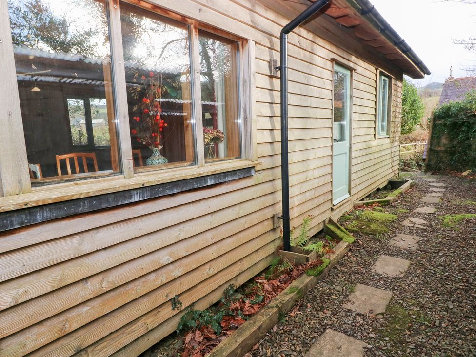 An exterior view of a wooden cabin with a pathway at Cabin in Newport