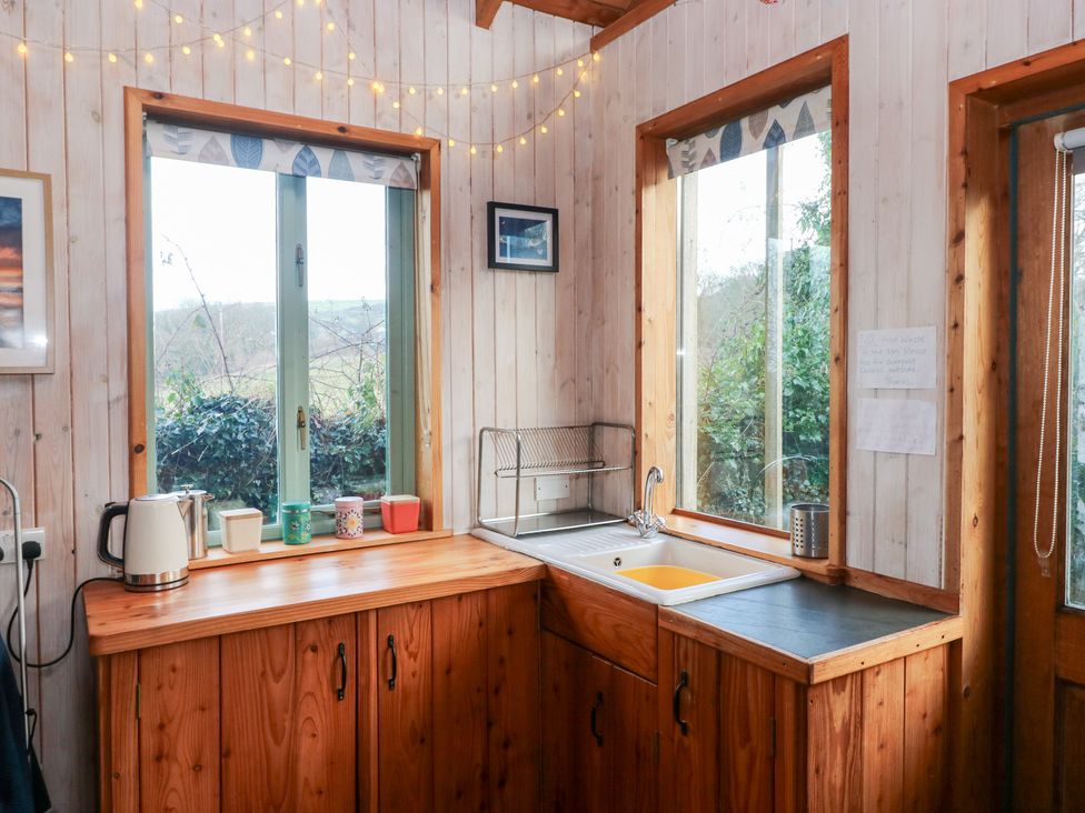 A kitchen with a sink and kettle at Cabin in Newport