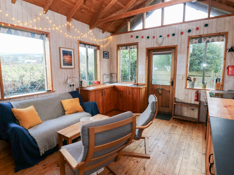A living room with a sofa and chairs at Cabin in Newport