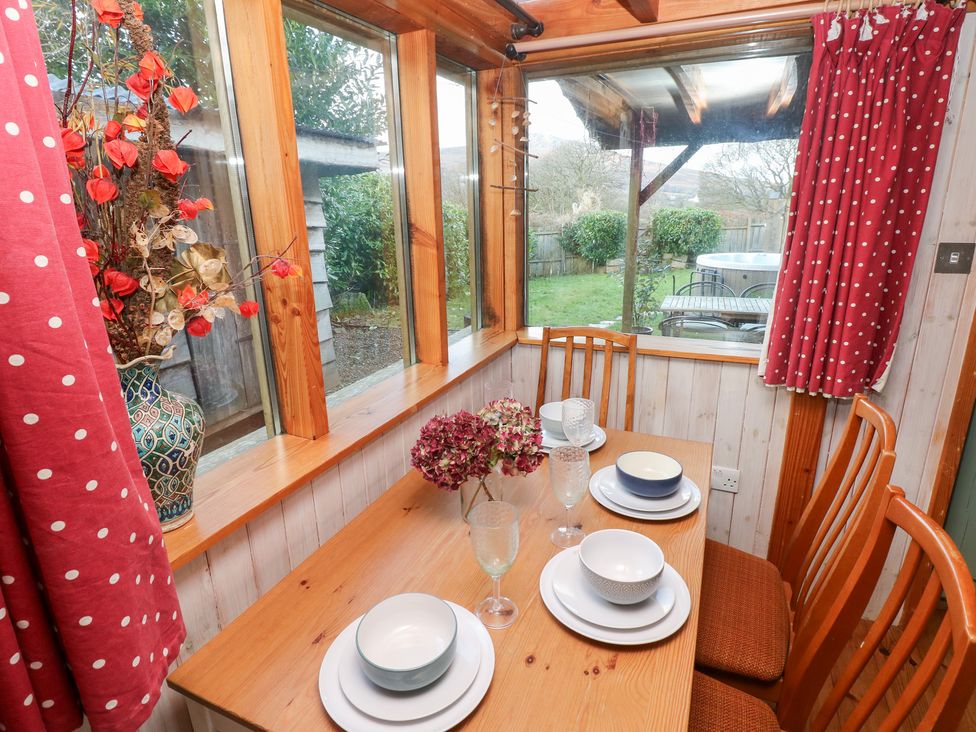 A dining room with a table set for four at Cabin in Newport