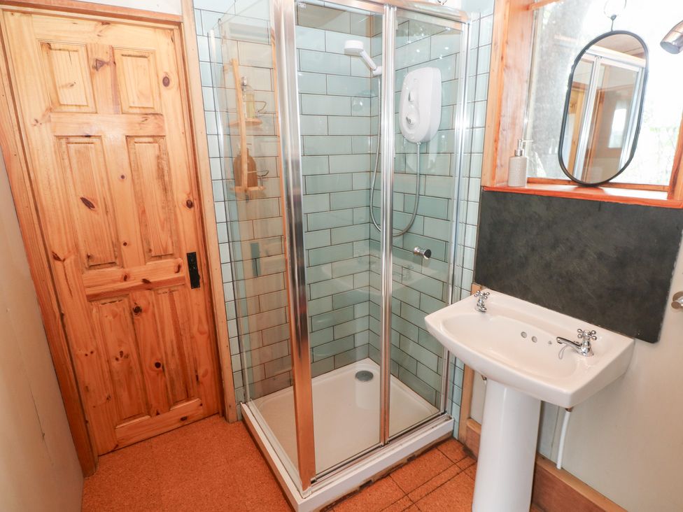 A bathroom with a shower and sink at Cabin in Newport