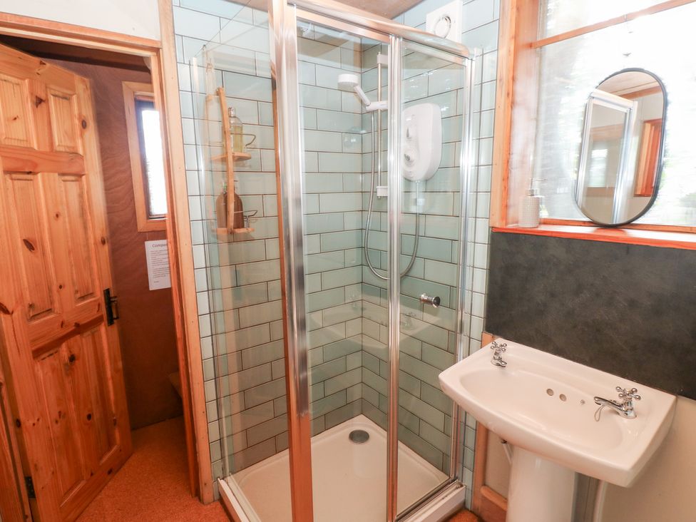 A bathroom with a shower and sink at Cabin in Newport