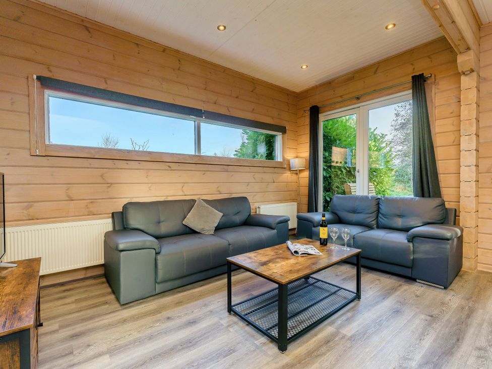 A living room with sofas and a coffee table at Poplar Lodge (Pet) Thirsk