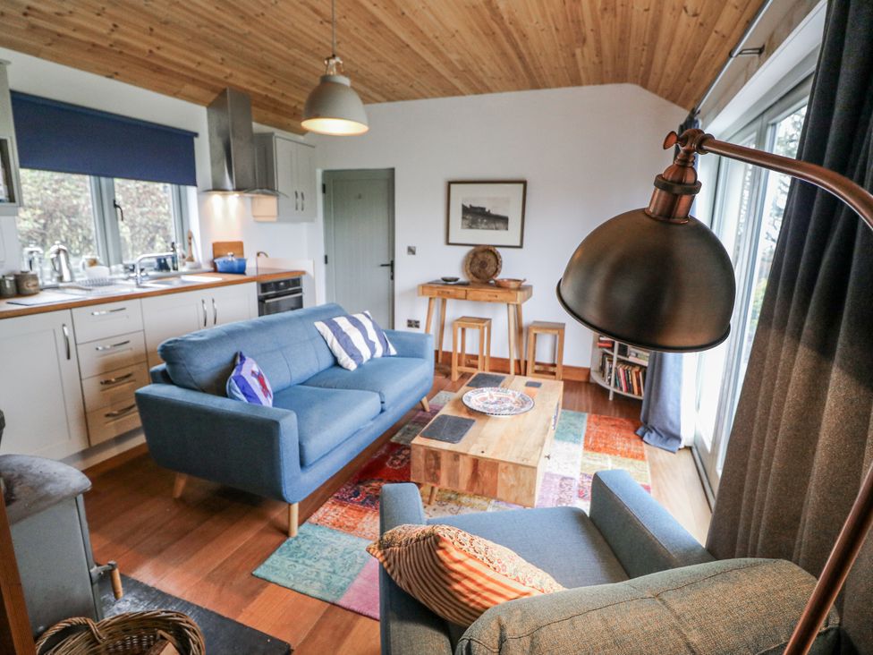 A living room with a sofa and coffee table at The Faithfuls Cabin in Dingle