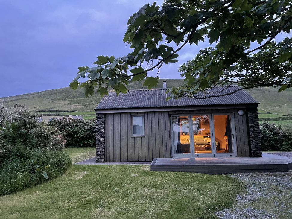 A cabin with a large window and door in Dingle, County Kerry