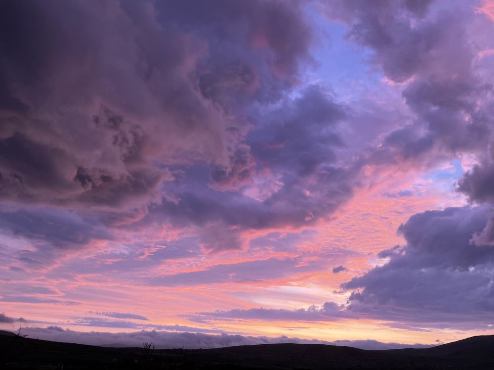 A sunset with clouds in the sky at The Faithfuls Cabin in Dingle, County Kerry