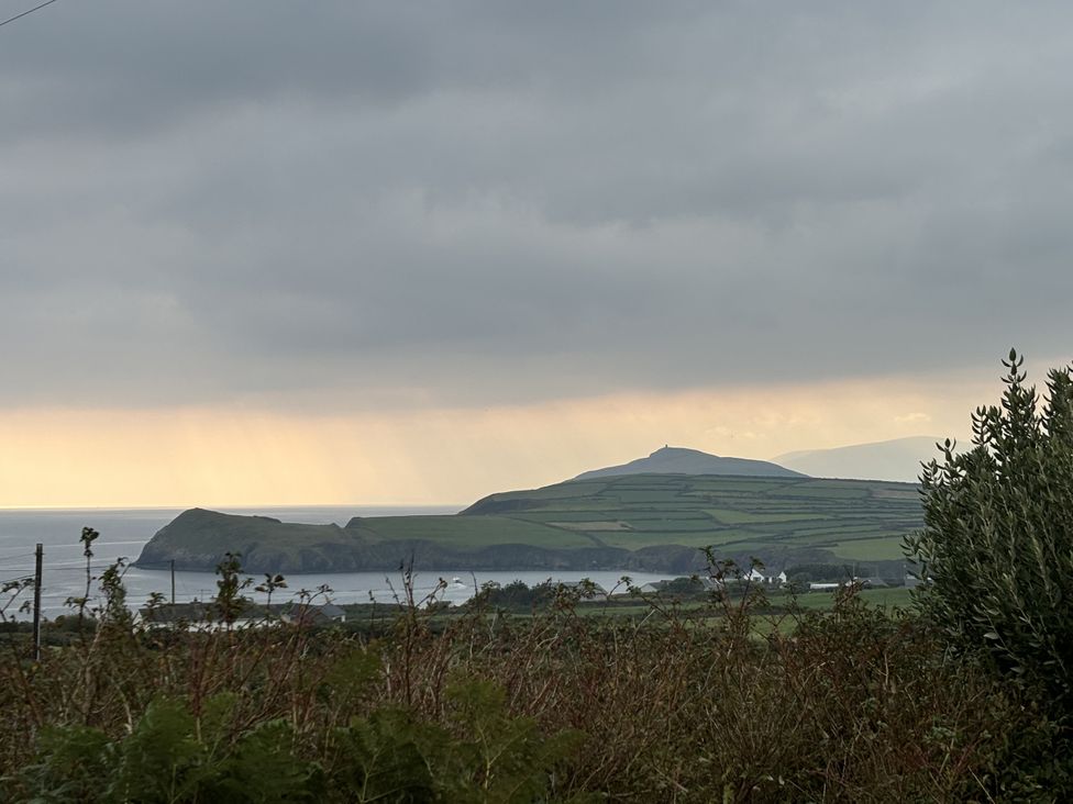 A coastal landscape with hills and ocean at The Faithfuls Cabin Dingle, County Kerry