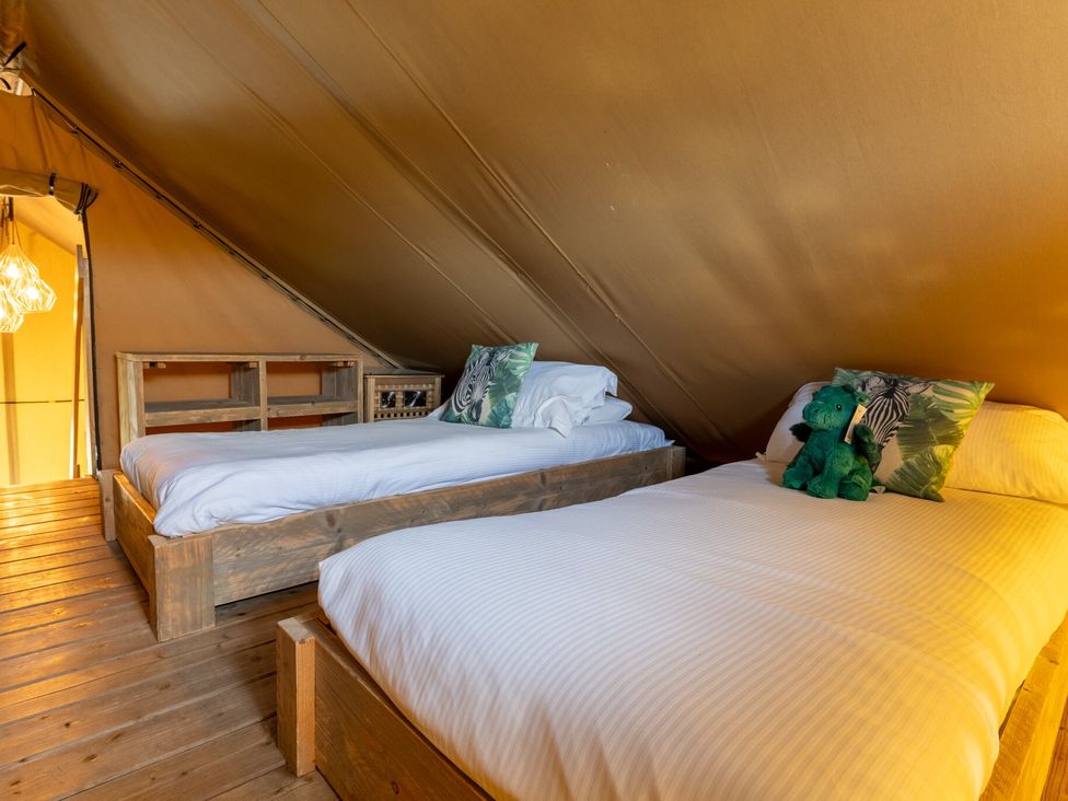 A bedroom with two beds and a stuffed animal at Kruger (Pet) in Penrith