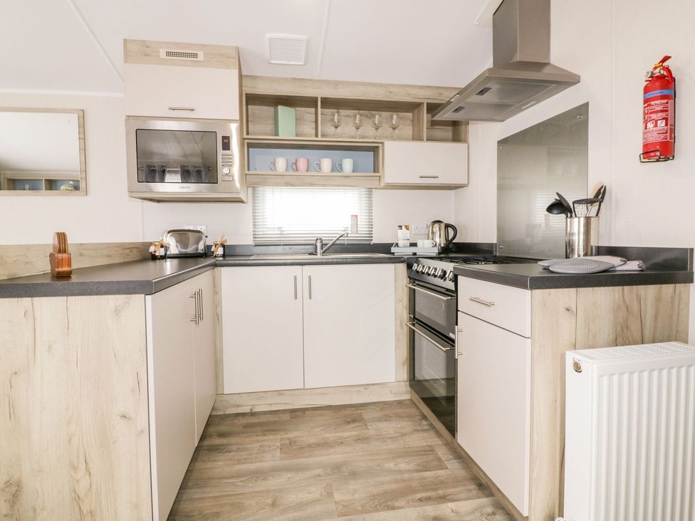A kitchen with appliances and cabinets at Barney's Retreat in Newquay