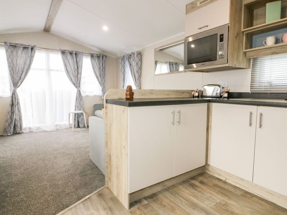A kitchen with a microwave and a toaster at Barney's Retreat in Newquay