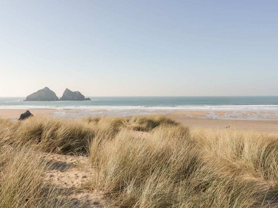 A beach with sand and ocean view at Barney's Retreat in Newquay