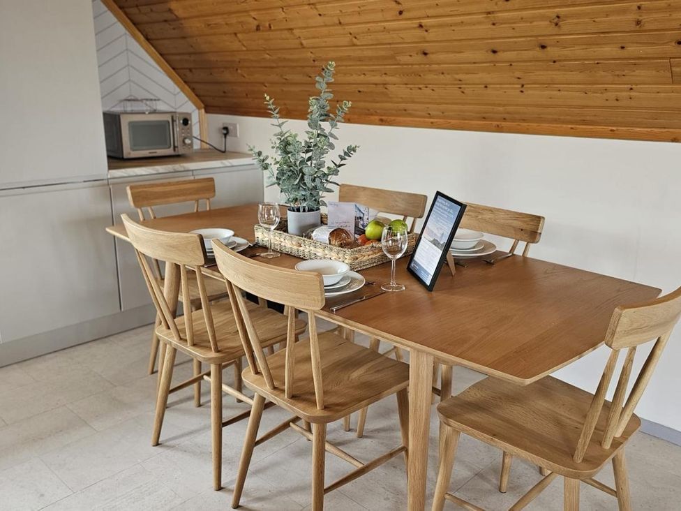 A dining room with a table set for meals at Kinder Lodge 3 Portreath