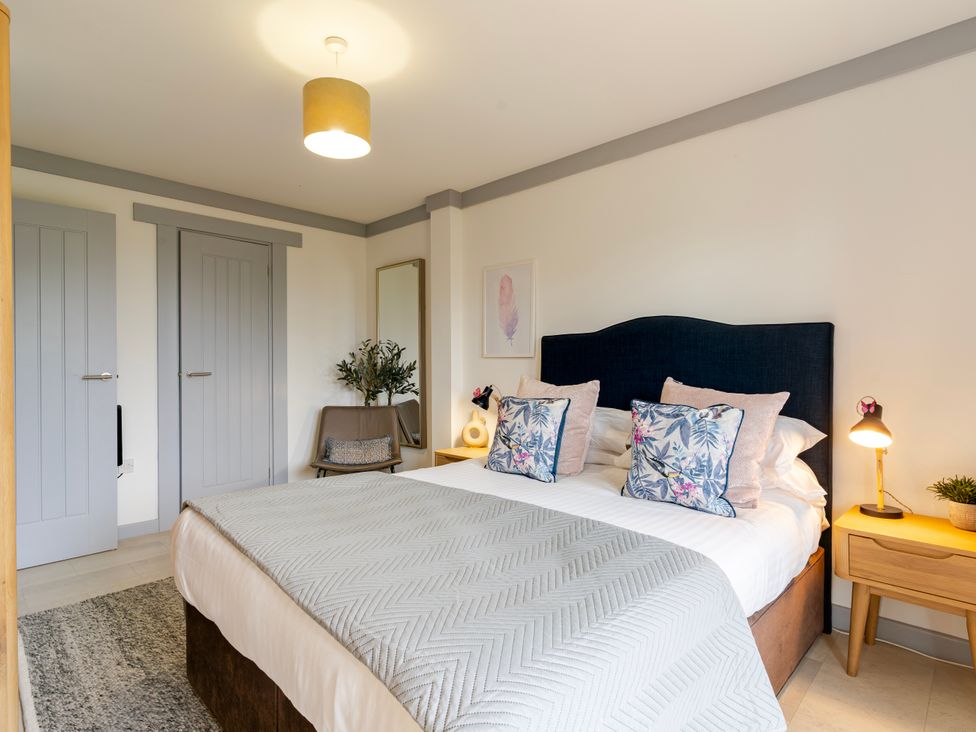 A bedroom with a bed and bedside table at Kinder Lodge 3 Spa (Pet) Redruth