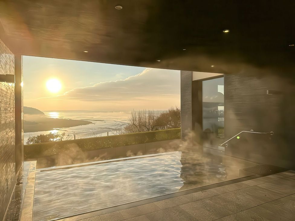 A spa with a swimming pool overlooking the ocean at Sonnet 3 Spa Laugharne