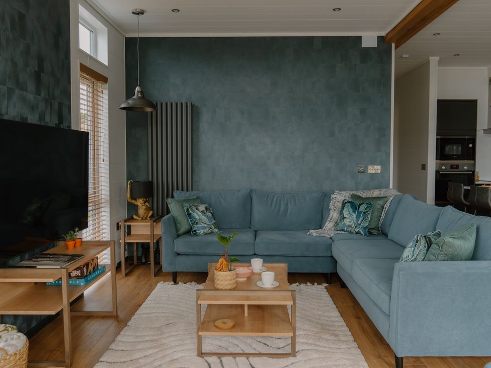 A living room with a sofa and coffee table at Wilde Spa (Pet) in Carmarthen