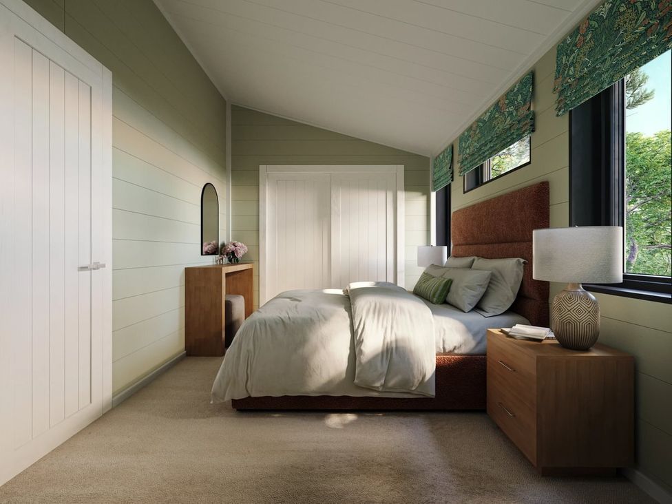 A bedroom with a bed and bedside table at Hesk (Pet) in Penrith