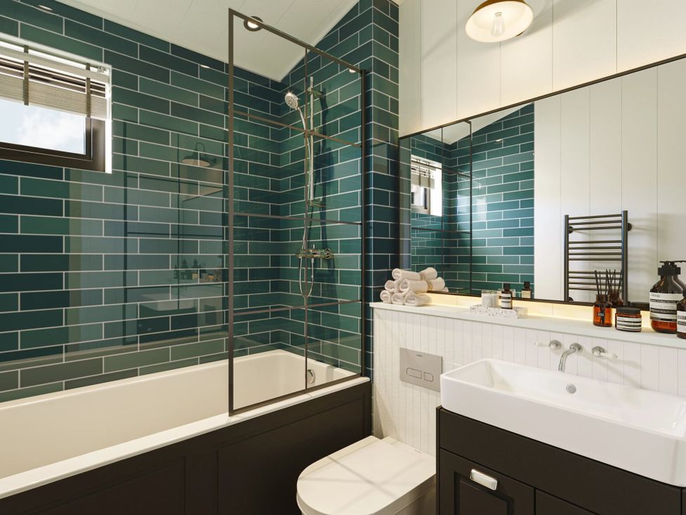 A bathroom with a bathtub and shower at Wansfell (Pet) Penrith