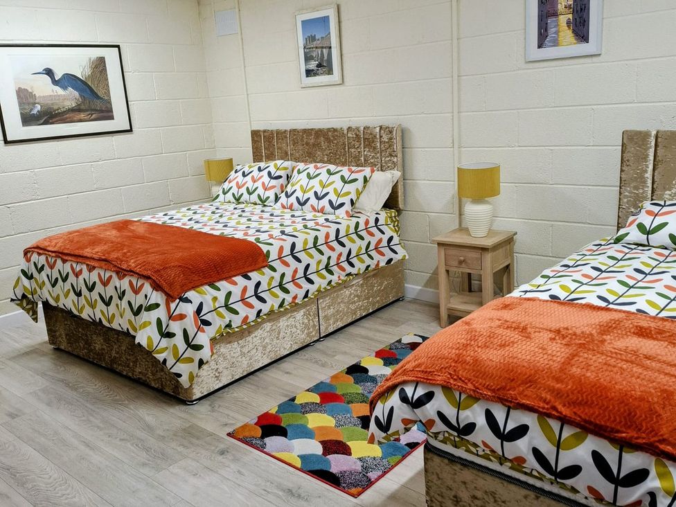 A bedroom with two beds and a bedside table at Radharc an Hook @ Estuary Bliss, Duncannon, County Wexford