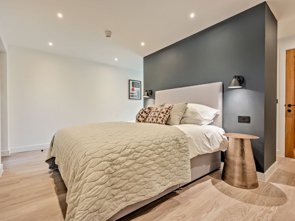A bedroom with a bed and bedside table at Arvor Studio 1.0 in Bude