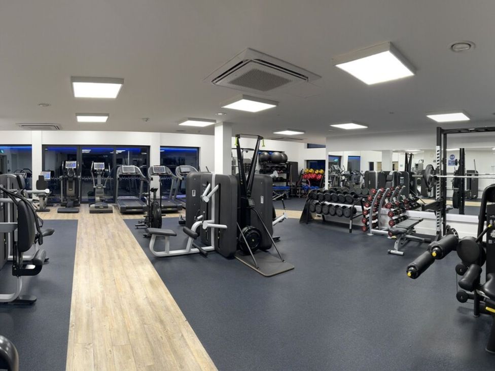 A gym with exercise equipment including treadmills and weight benches at Arvor Studio 1.0 Marhamchurch