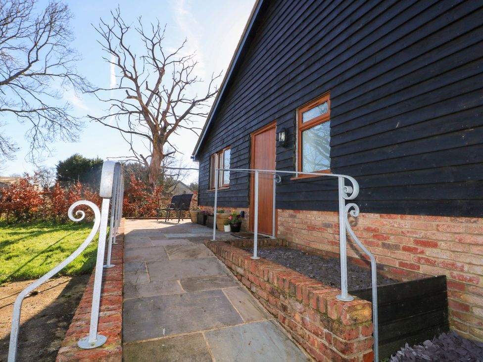 An outdoor area with steps and furniture at Blue Bell Cottage near Lenham