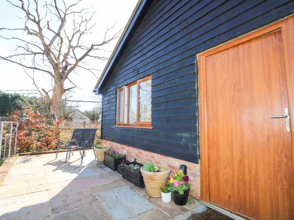An outdoor area with a door and potted plants at Blue Bell Cottage near Lenham