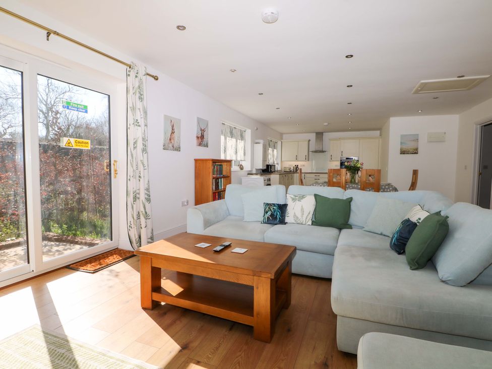 A living room with a sofa and coffee table at Blue Bell Cottage near Lenham