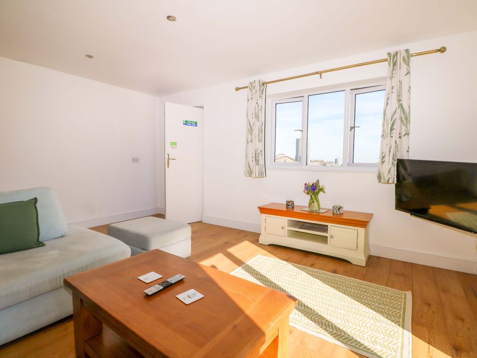 A living room with a sofa and coffee table at Blue Bell Cottage near Lenham