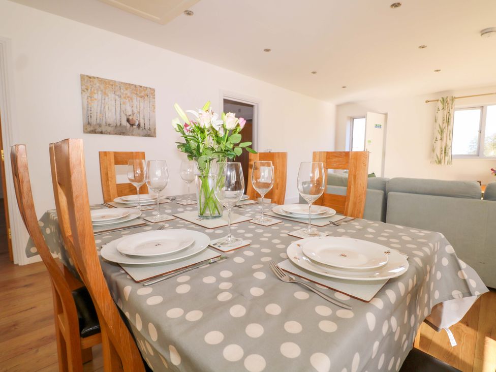 A dining table set with plates and glasses at Blue Bell Cottage near Lenham