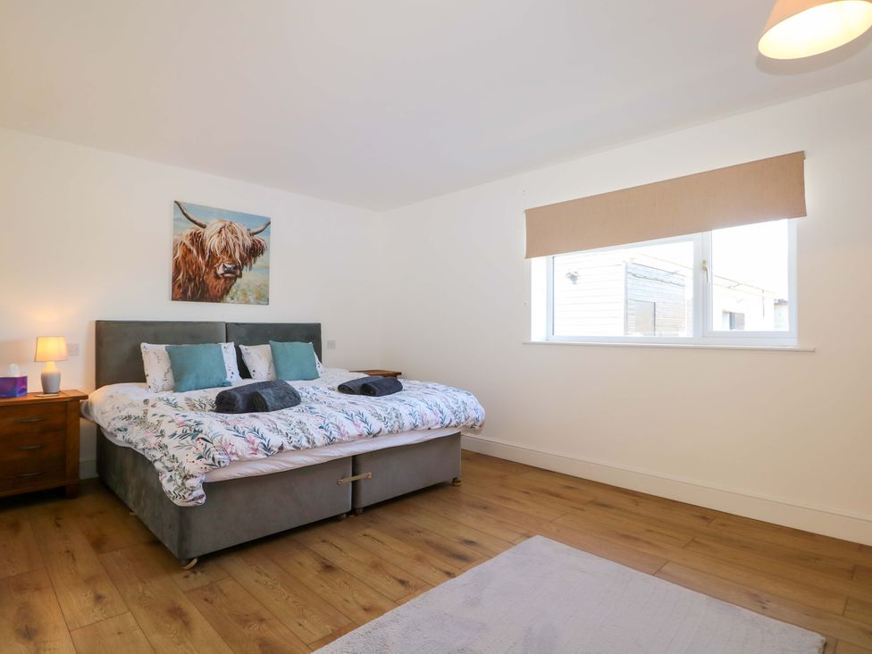 A bedroom with a bed and bedside table at Blue Bell Cottage near Lenham