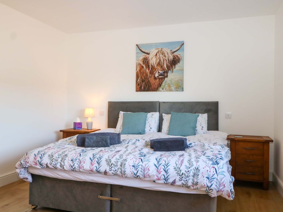A bedroom with a bed and bedside table at Blue Bell Cottage near Lenham