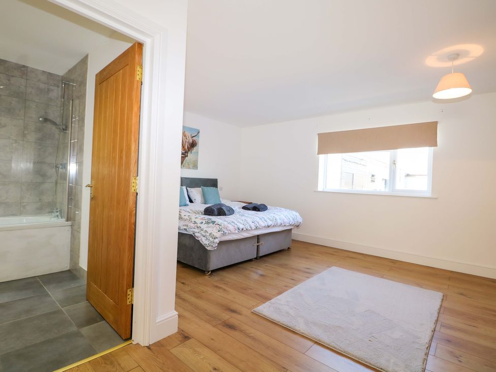 A bedroom with a bed and shower room at Blue Bell Cottage near Lenham